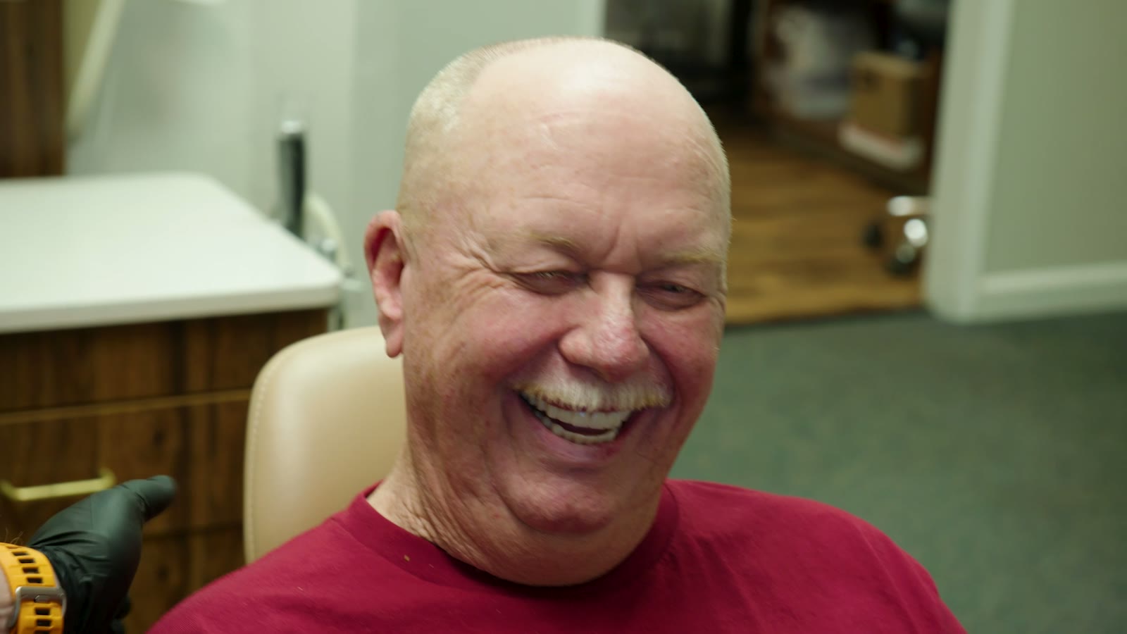 A Tim Rauch DDS patient laughing during a routine visit